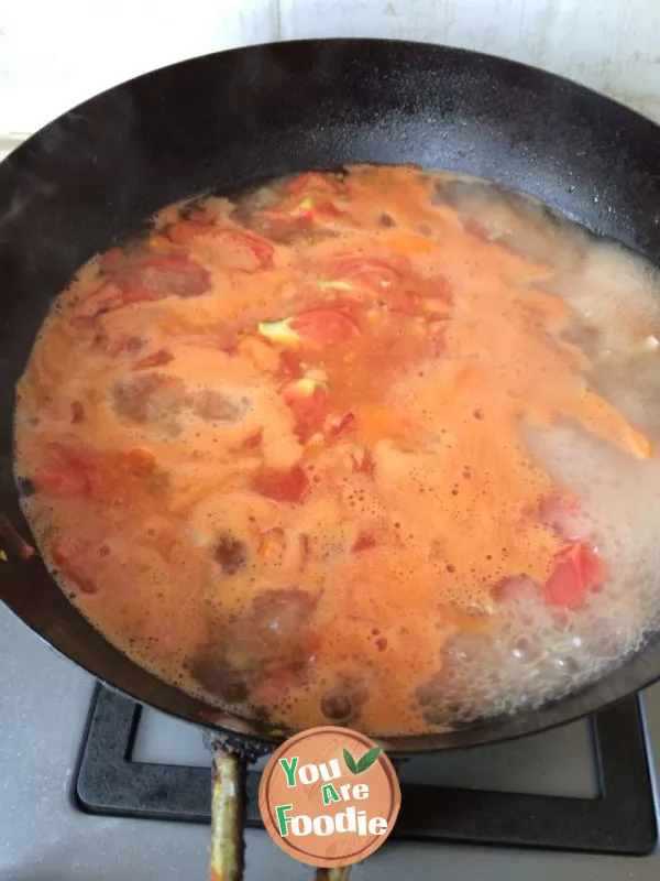 Vegetable noodles in red soup