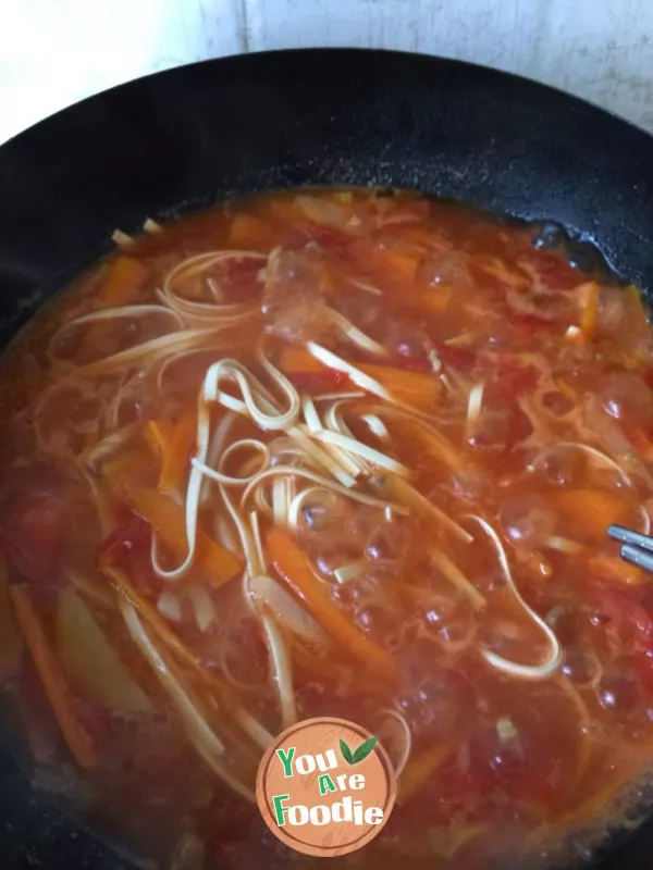 Vegetable noodles in red soup