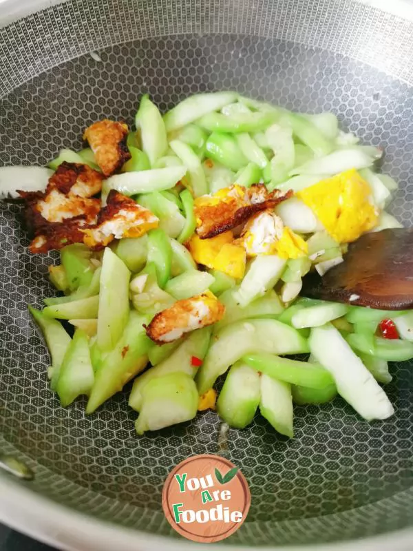 Fried poached egg with towel gourd