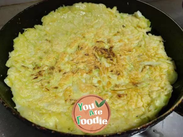 Fried pancakes with shredded cabbage and eggs