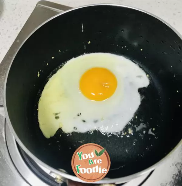 Fried egg with tomato sauce