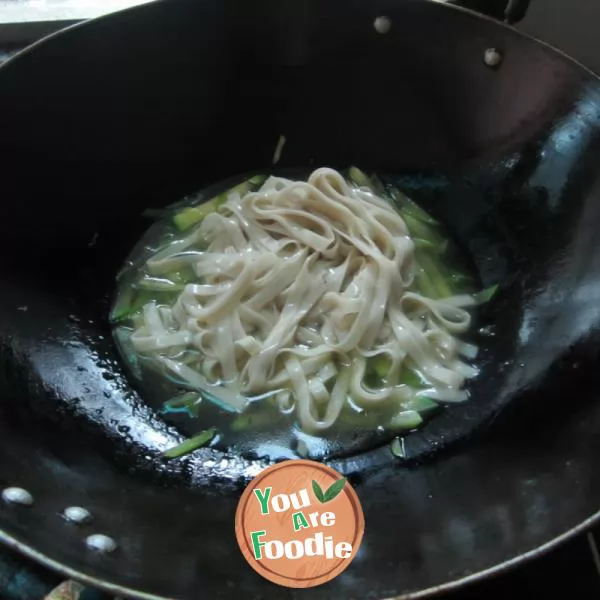 Boiled noodles with pumpkin shreds in broth