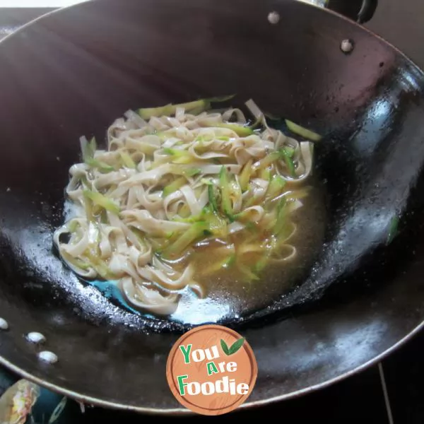 Boiled noodles with pumpkin shreds in broth