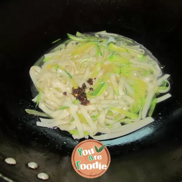 Boiled noodles with pumpkin shreds in broth