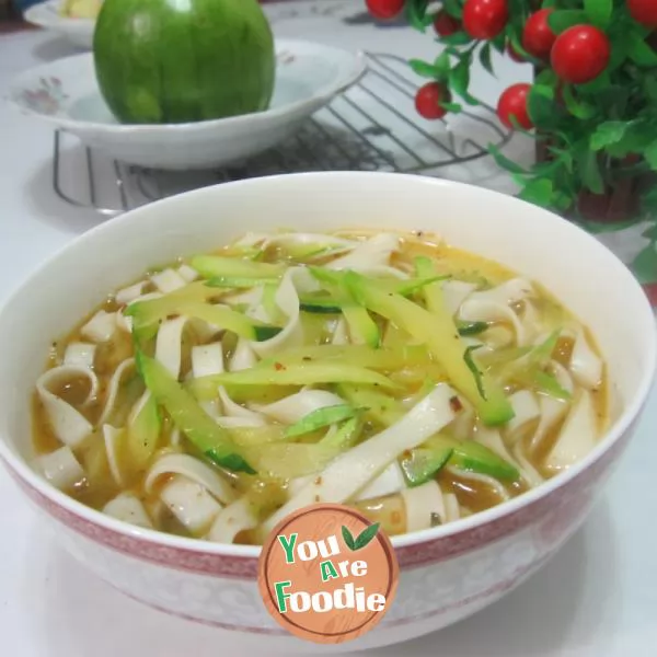 Boiled noodles with pumpkin shreds in broth