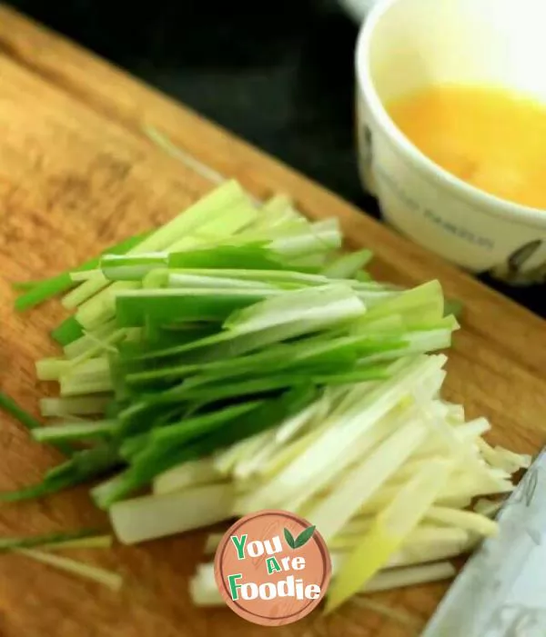 A bowl of noodles with scallion oil