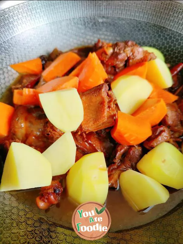 Braised duck legs with potatoes and carrots