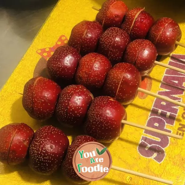 candied gourd on a stick