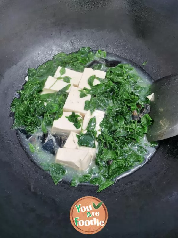 Preserved egg tofu dog liver vegetable soup