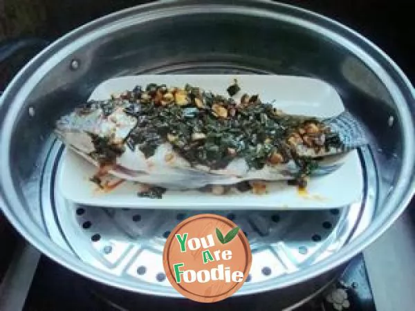 Steamed fish with ginger leaves in chili sauce