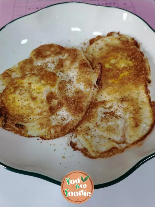 Fried egg with pepper and salt