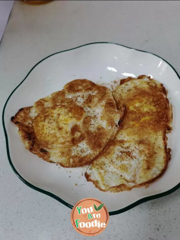 Fried egg with pepper and salt