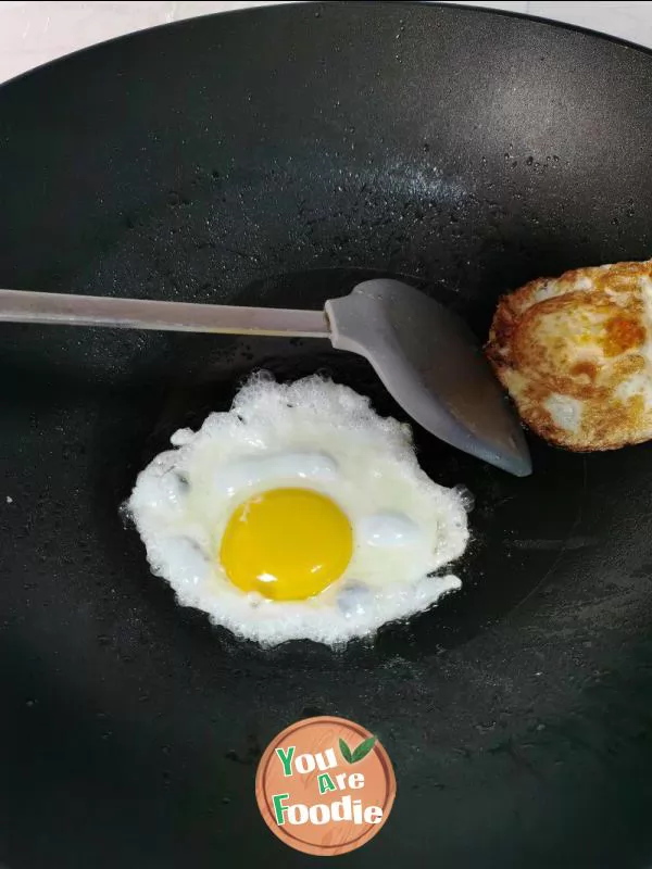 Fried egg with pepper and salt