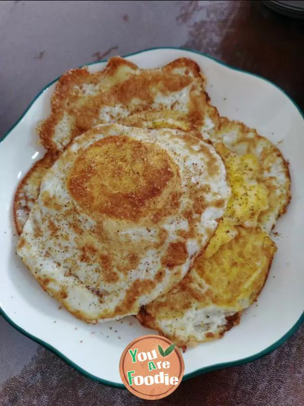 Fried egg with pepper and salt