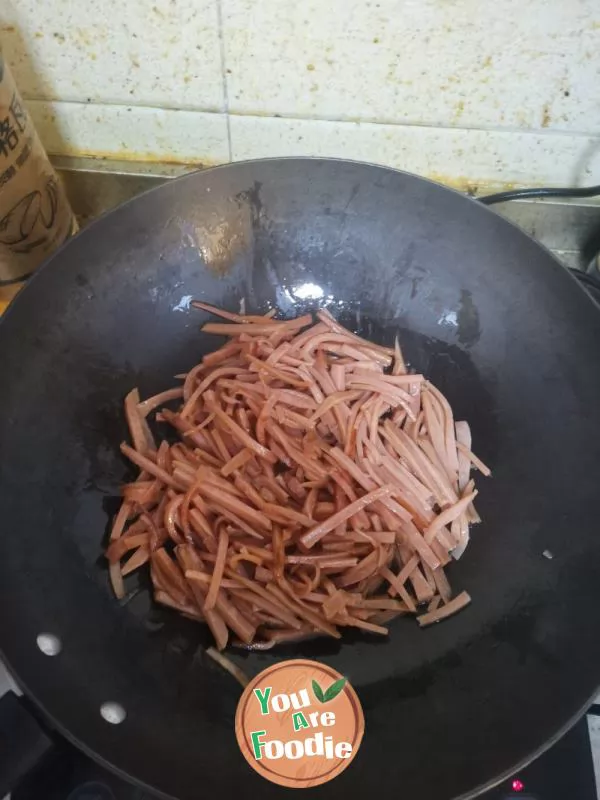 Stir fried ham sausage with garlic sprouts