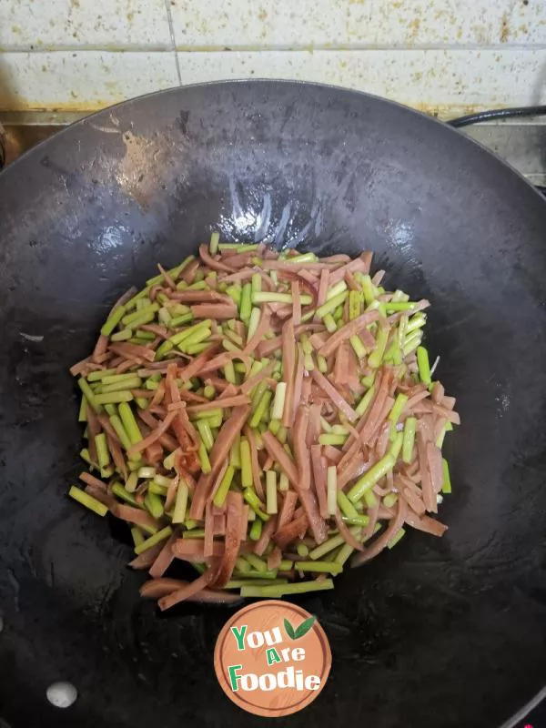 Stir fried ham sausage with garlic sprouts