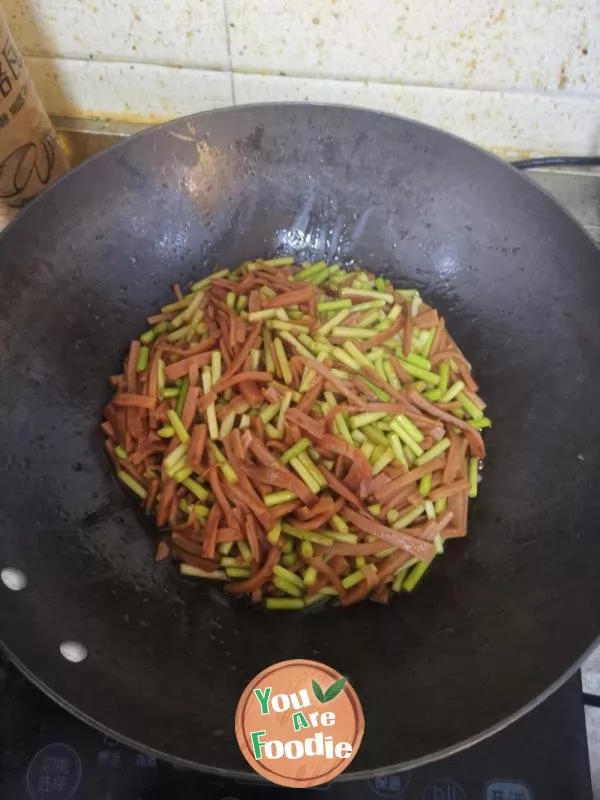 Stir fried ham sausage with garlic sprouts